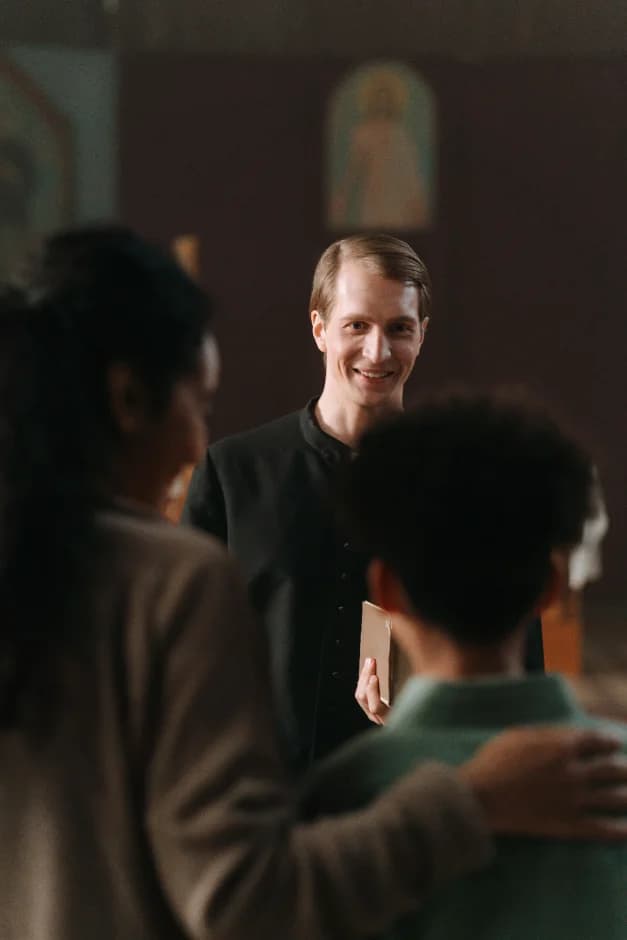 Volunteer greeting a new family at the welcome desk