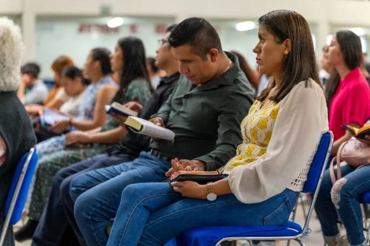 Small class gathered around a table with Bibles