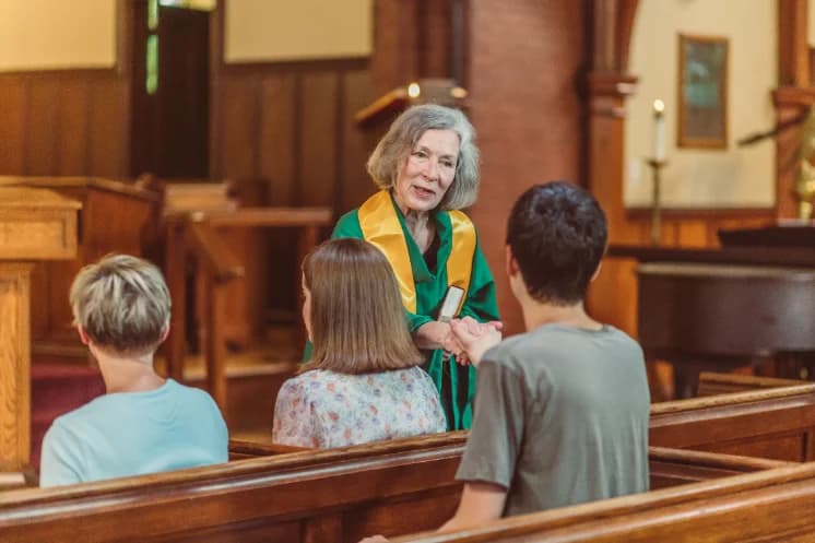Greeter welcoming a family at the church door
